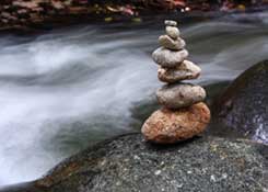 Healing Stones Stacked by Flowing River